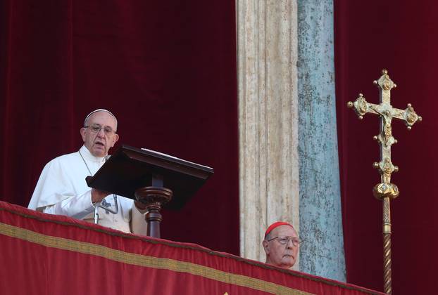 Pope Francis leads the "Urbi et Orbi" (to the city and the world) message from the balcony overlooking St. Peter