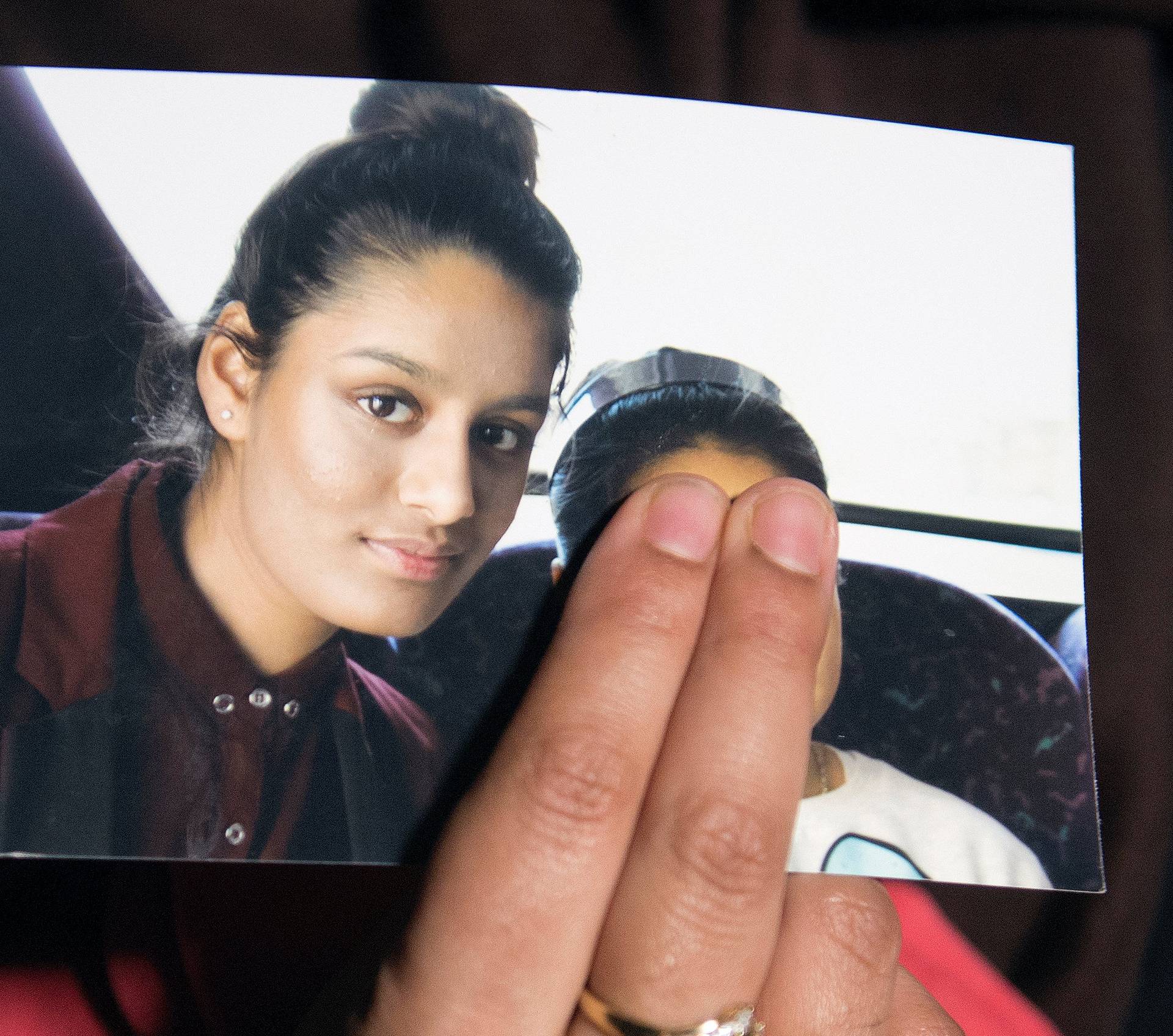 FILE PHOTO: Renu Begum, sister of teenage British girl Shamima Begum, holds a photo of her sister as she makes an appeal for her to return home at Scotland Yard, in London