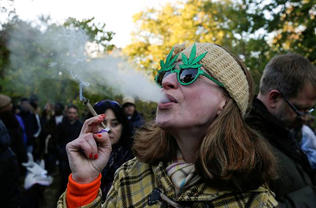 A woman smokes a joint on the day Canada legalizes recreational marijuana at Trinity Bellwoods Park in Toronto