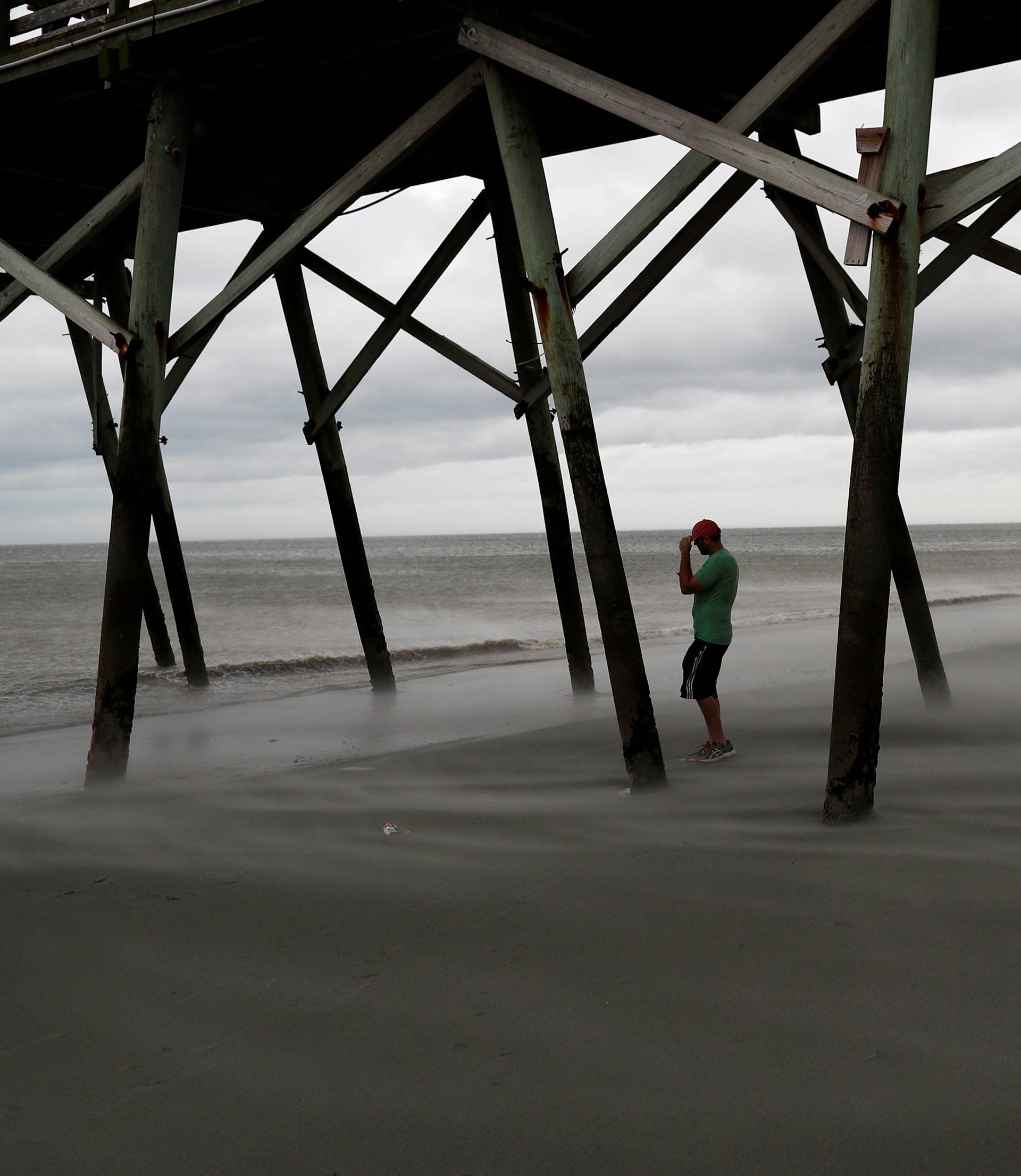 Matt Stone of Surfside Beach checks out the winds on the beach during Hurricane Florence in Surfside Beach