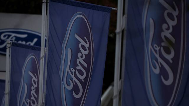 Signage is seen outside a Ford motor dealership in Manchester, Britain