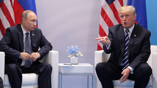 U.S. President Donald Trump gestures as he meets with Russian President Vladimir Putin during their bilateral meeting at the G20 summit in Hamburg