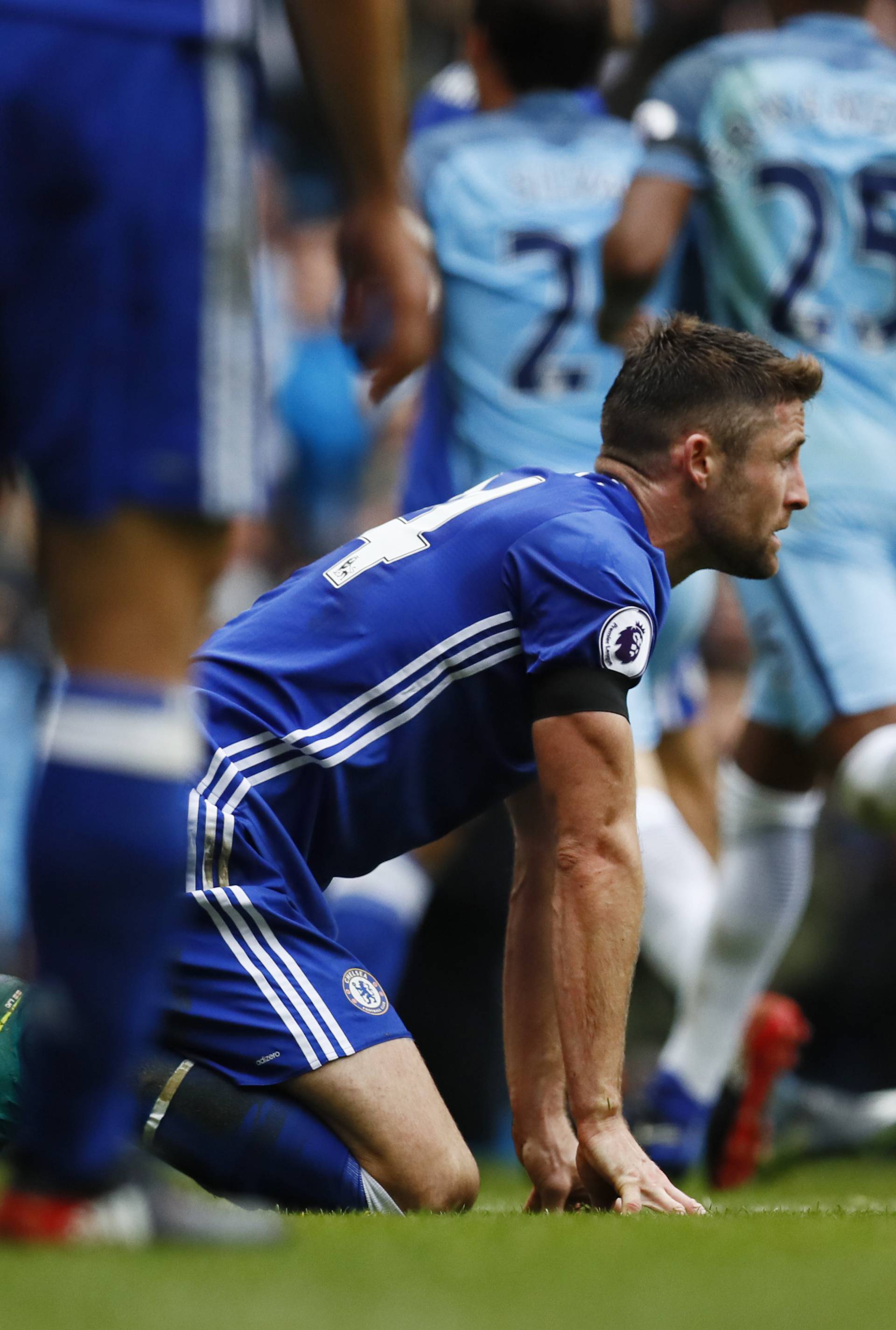 Chelsea's Gary Cahill looks dejected after scoring an own goal and the first goal for Manchester City