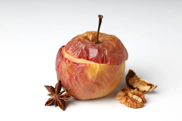 Concept of tasty food with baked apple on white background