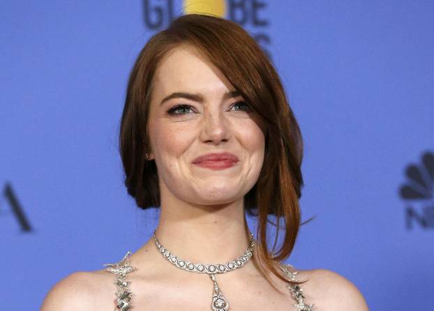 Emma Stone poses with her award during the 74th Annual Golden Globe Awards in Beverly Hills