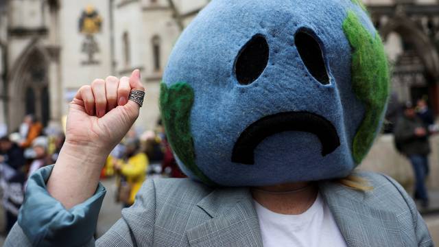 Climate activist demonstrates outside the high court in London