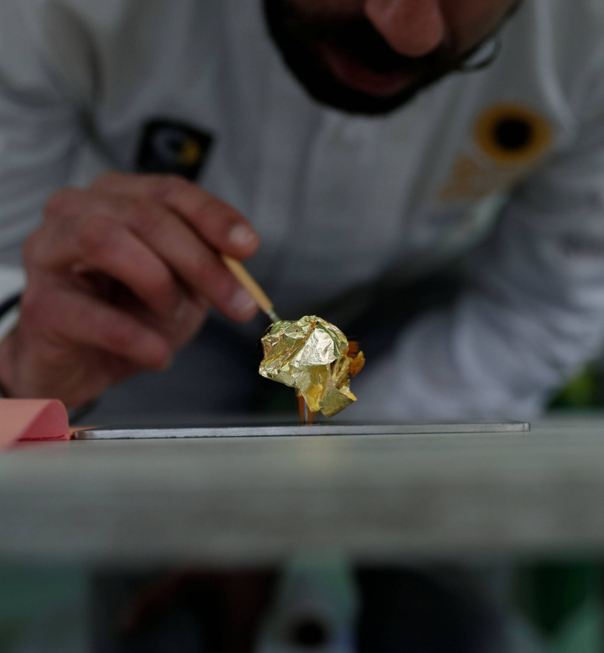 Portuguese chocolatier Daniel Gomes prepares a candy wrapped in pure 23 carat gold during international chocolate fair in Obidos