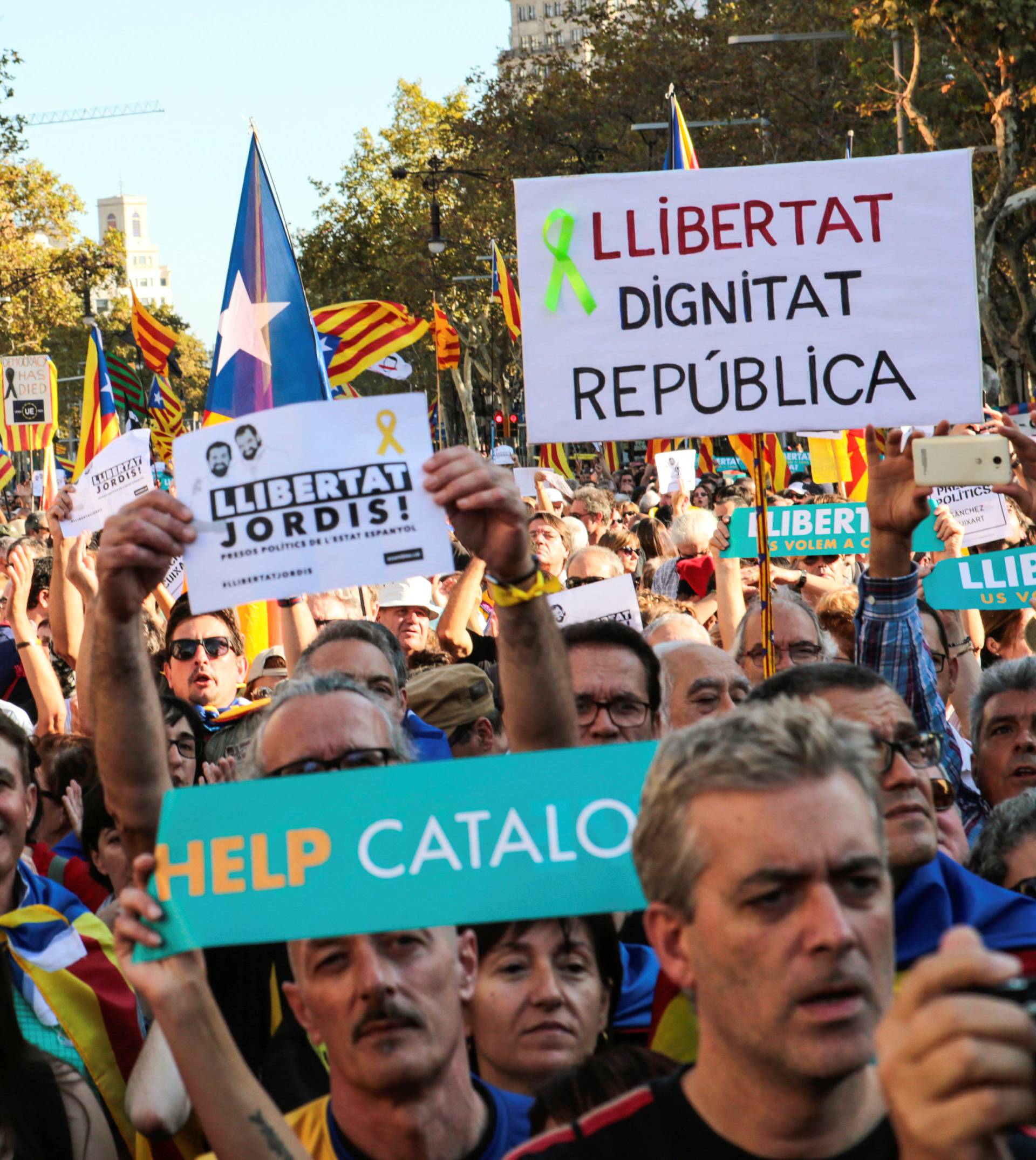 People hold banners and flags during a demonstration organised by Catalan pro-independence movements ANC (Catalan National Assembly) and Omnium Cutural, following the imprisonment of their two leaders, in Barcelona