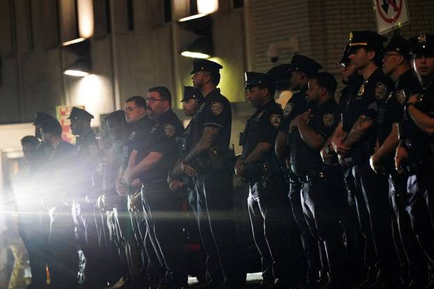 NYPD officers wait for the ambulance transfer of slain NYPD officer Didarul Islam,  in New York City