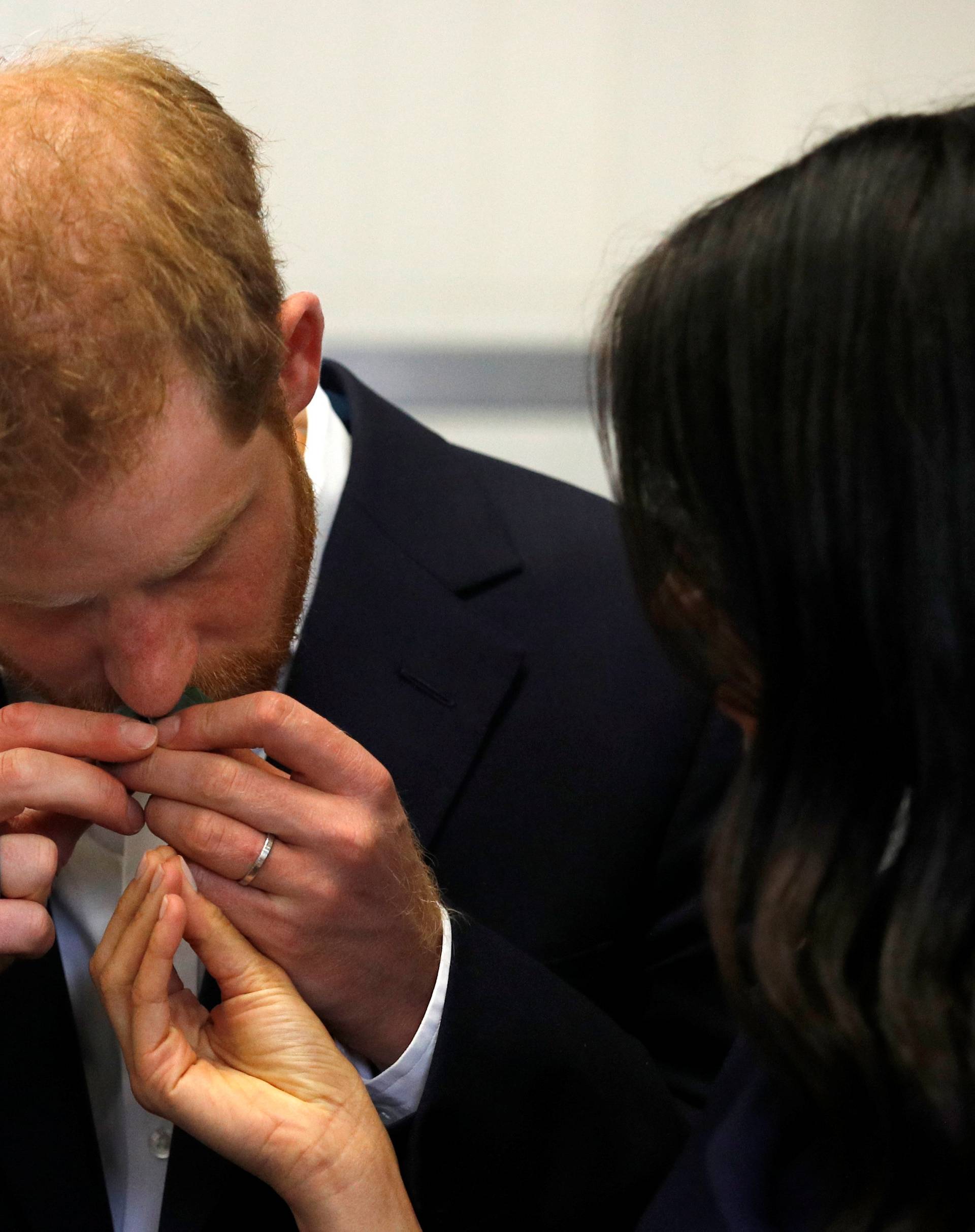 Britain's Prince Harry and his wife, Meghan, Duchess of Sussex, visit a social enterprise restaurant in Melbourne