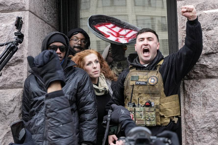 People attend the "March Against Minnesota Fraud" in Minneapolis