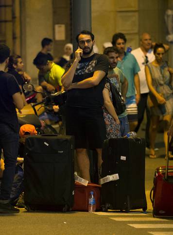 People wait to enter the area after a van crashed into pedestrians near the Las Ramblas avenue in central Barcelona