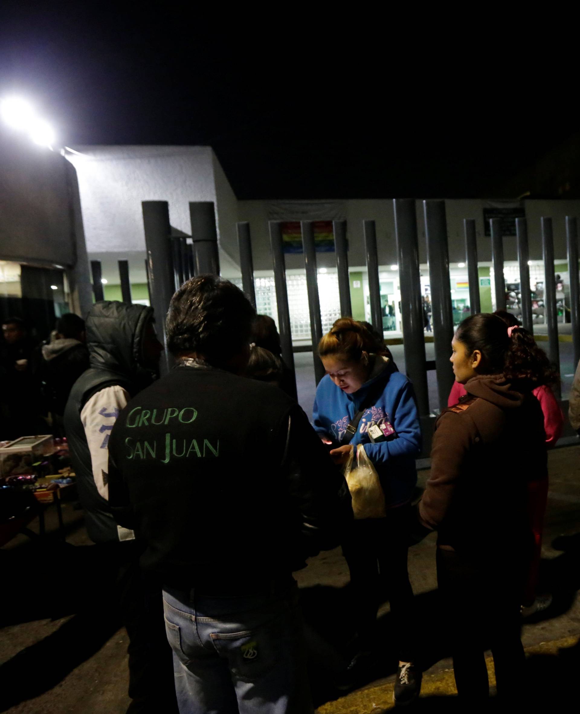 Family members and friends of victims of an explosion at a fireworks market wait outside a hospital in Coacalco