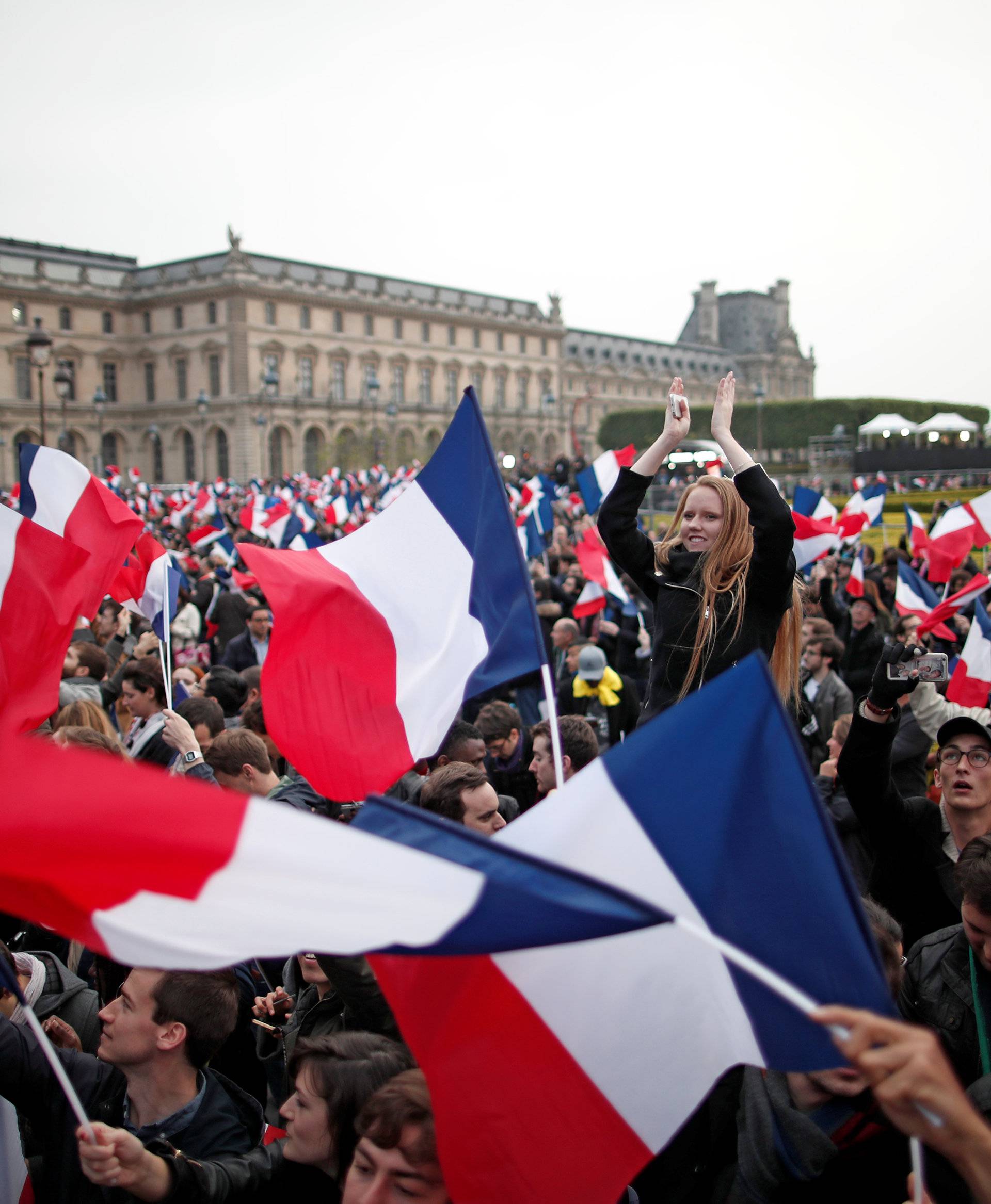 Supporters of President Elect Emmanuel Macron celebrate near the Louvre museum after results were announced in the second round vote of the 2017 French presidential elections, in Paris
