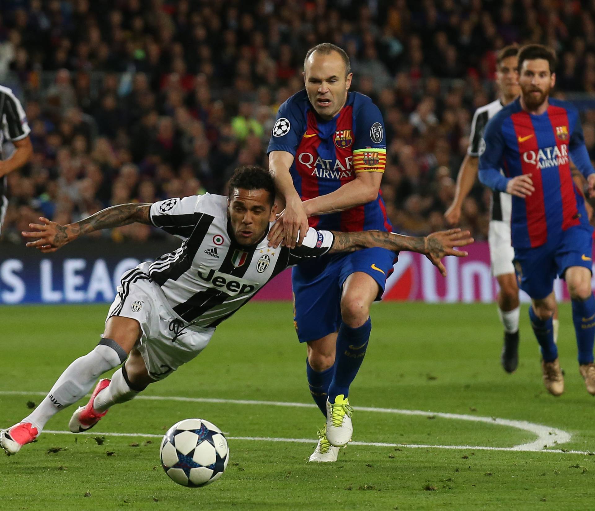 Barcelona's Andres Iniesta in action with Juventus' Dani Alves