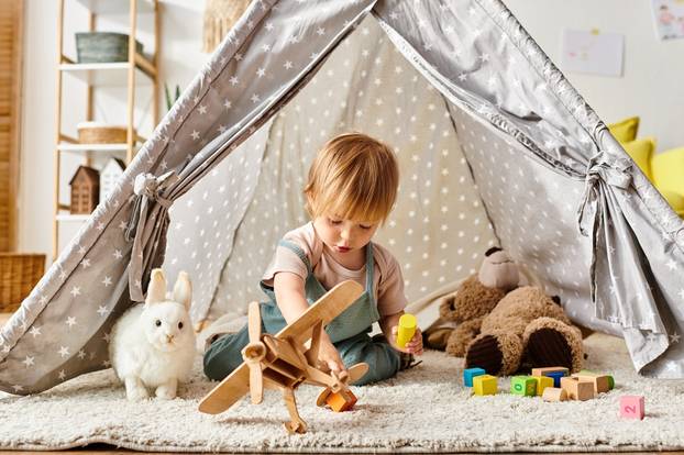 Toddler,Girl,Plays,Happily,With,Toys,Inside,A,Playful,Tent
