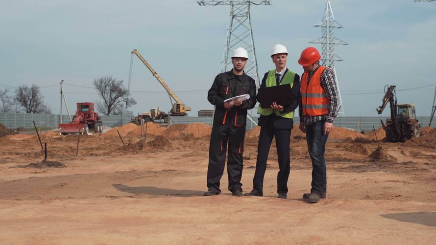 Engineers,And,Workers,Discuss,The,Plan,Of,Building,At,Building.