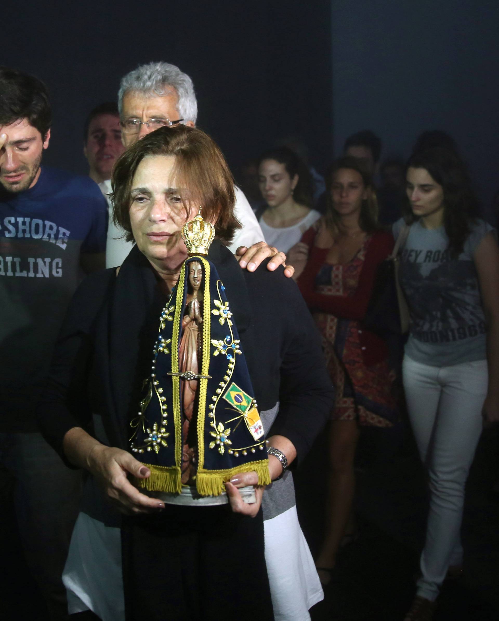Relatives of Brazilian journalist Guilherme Marques mourn during a mass in Rio de Janeiro
