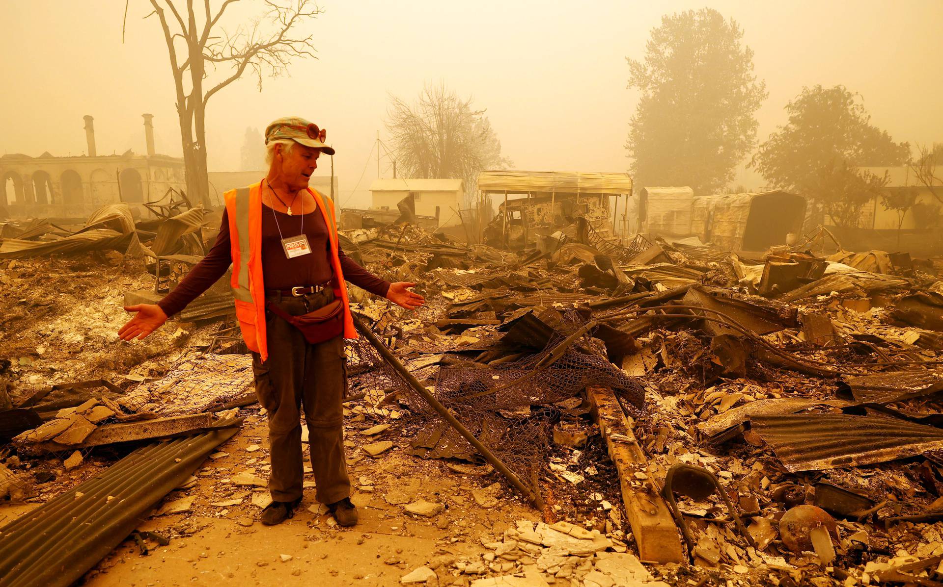 Greenville resident looks at the remains of his business after the Dixie Fire