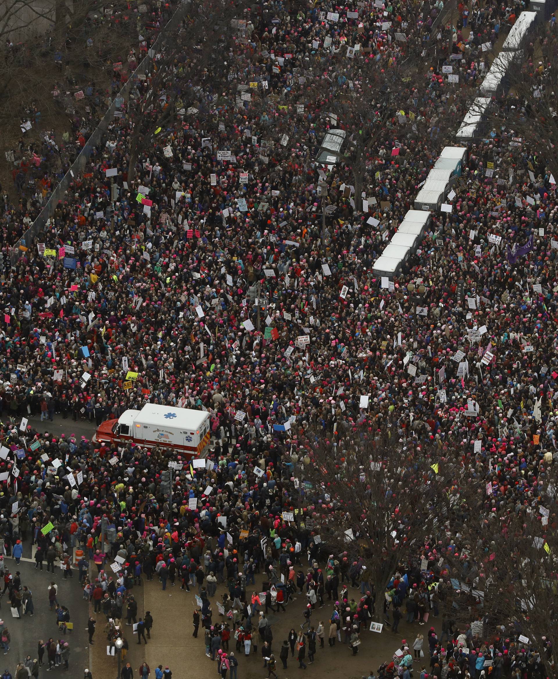 An ambulance drives through demonstrators taking part in the Women's March to protest Donald Trump's inauguration as the 45th president of the United States near the U.S. Capitol in Washington