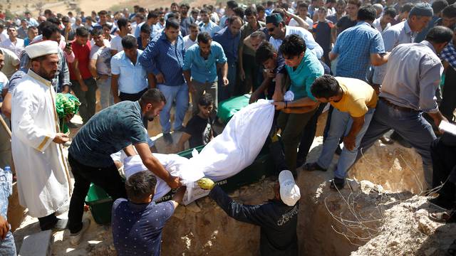 Mourners carry a victim's body who was killed in a suicide bomb attack at a wedding celebration, during a funeral ceremony in the southern Turkish city of Gaziantep