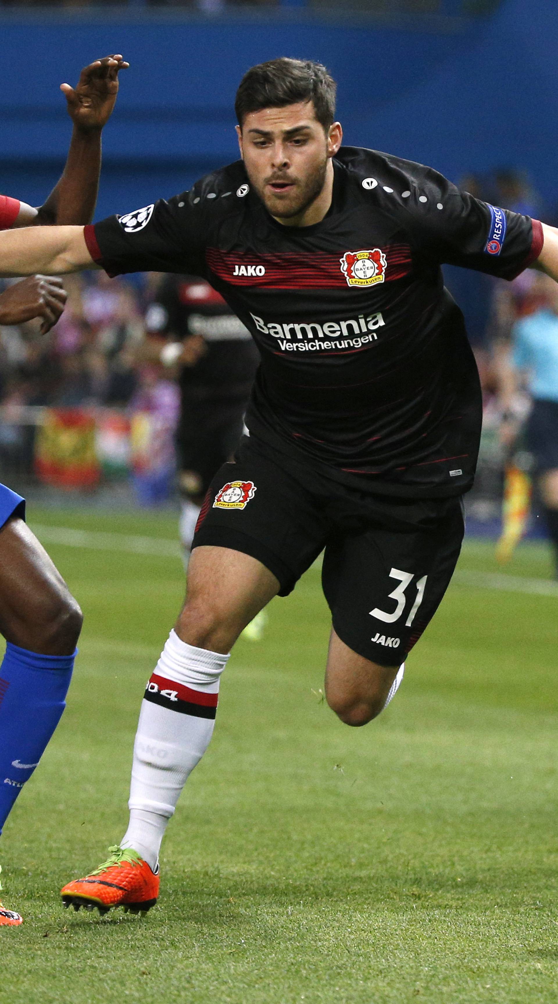 Atletico Madrid's Thomas in action with Bayer Leverkusen's Kevin Volland