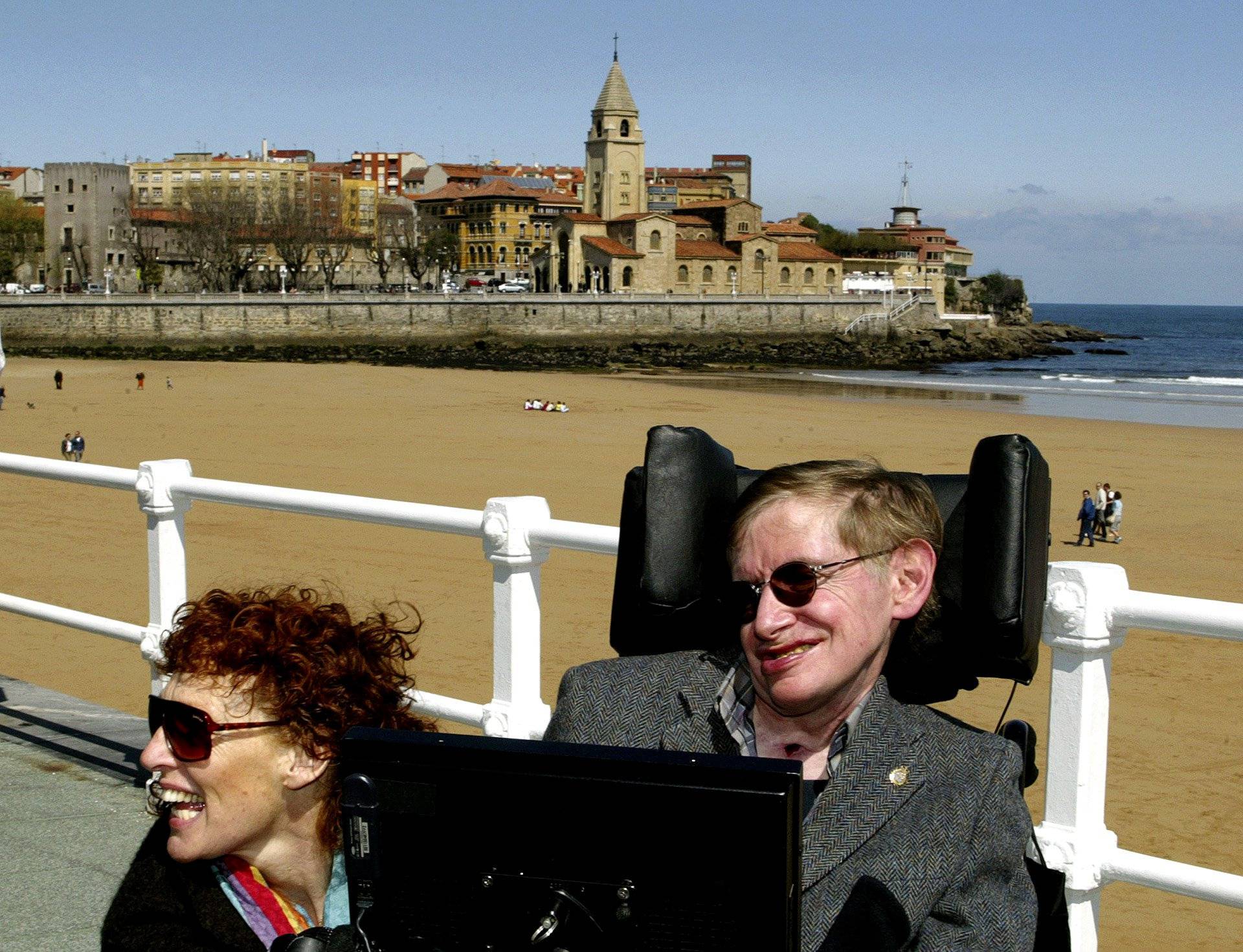FILE PHOTO: British astrophysicist Hawking and his wife Elaine pose in front of a beach in Spain.