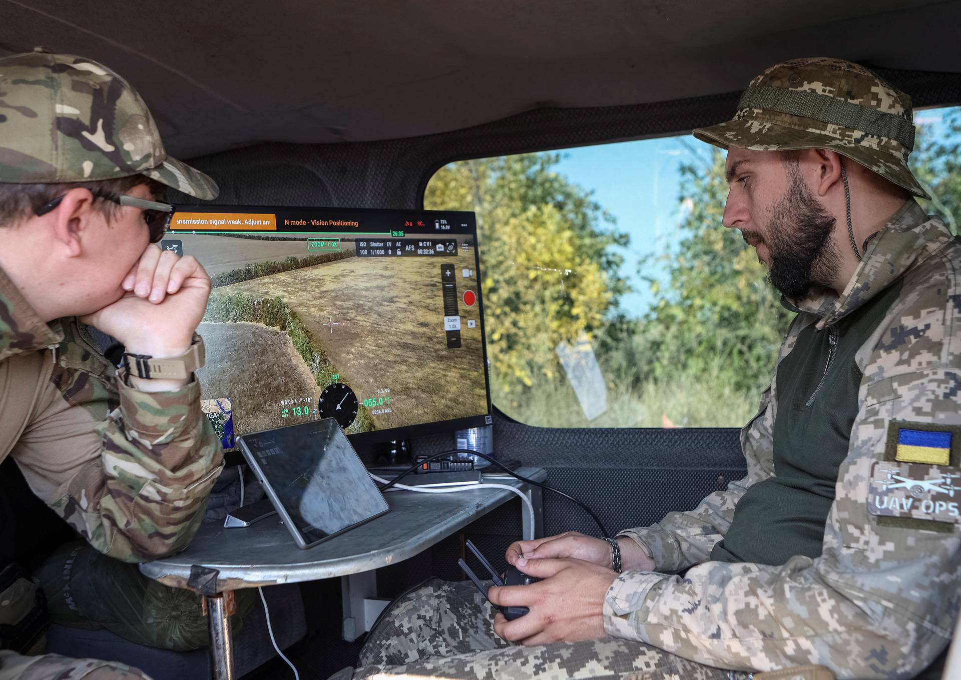 A member of the volunteer organization 'Postup' operates a drone during demining near the town of Derhachi