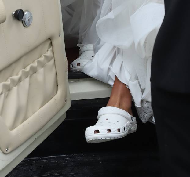 Tyson Fury’s eldest daughter Venezuela Fury arrives in a 50ft length fishtail white dress and crocs accompanied by her parents for her wedding to Noah Price