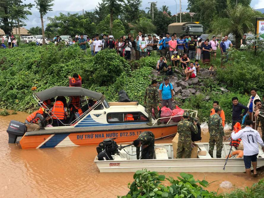 Rescuers work at a flooded site after a hydropower dam collapse in Attapeu Province
