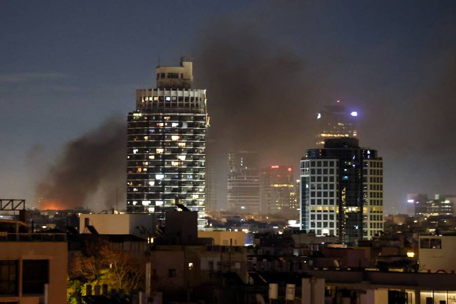 Smoke rises following an Iranian projectile strike in Tel Aviv