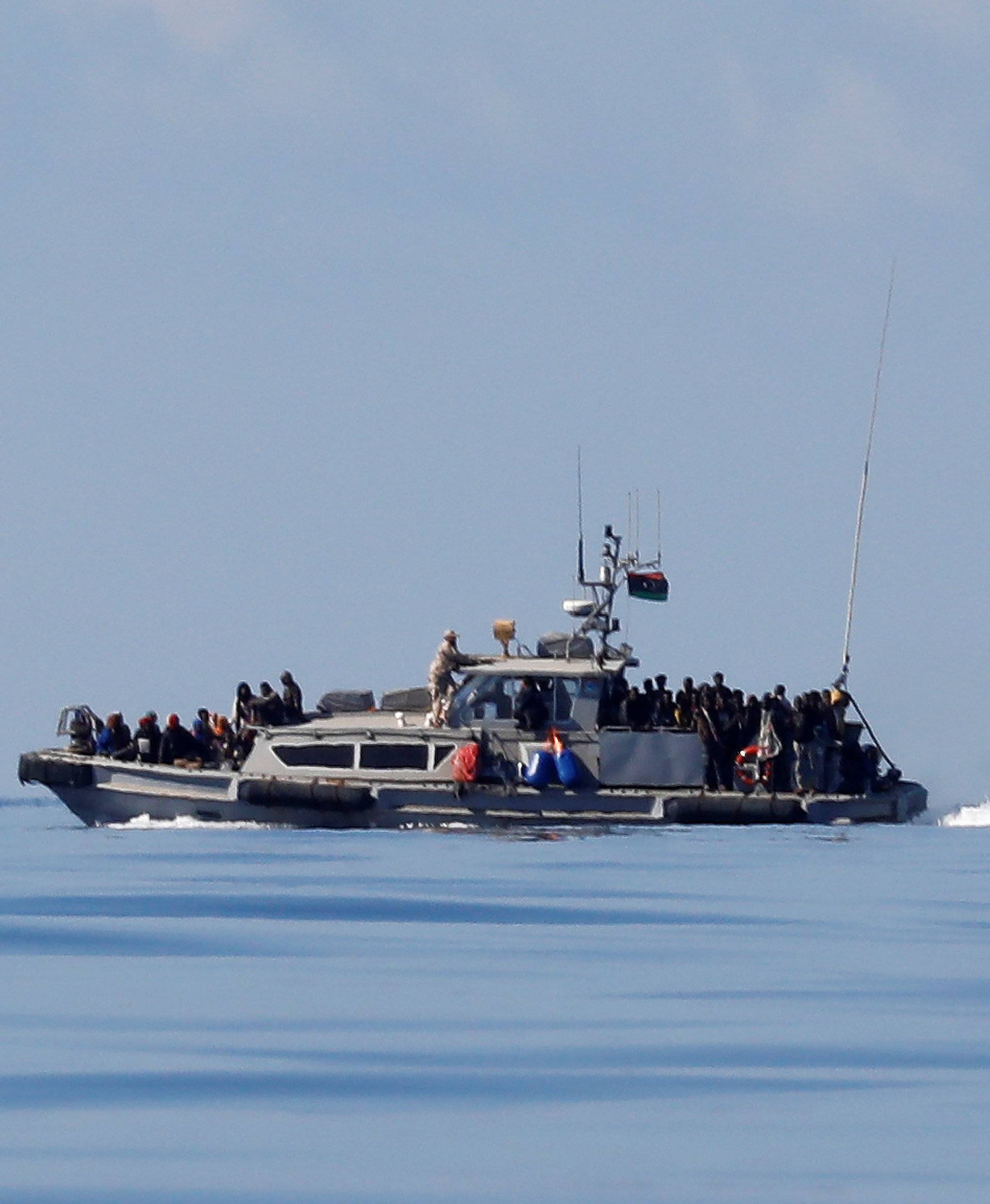 Migrants are seen onboard a Libyan Coast Guard vessel following a rescue operation in central Mediterranean Sea
