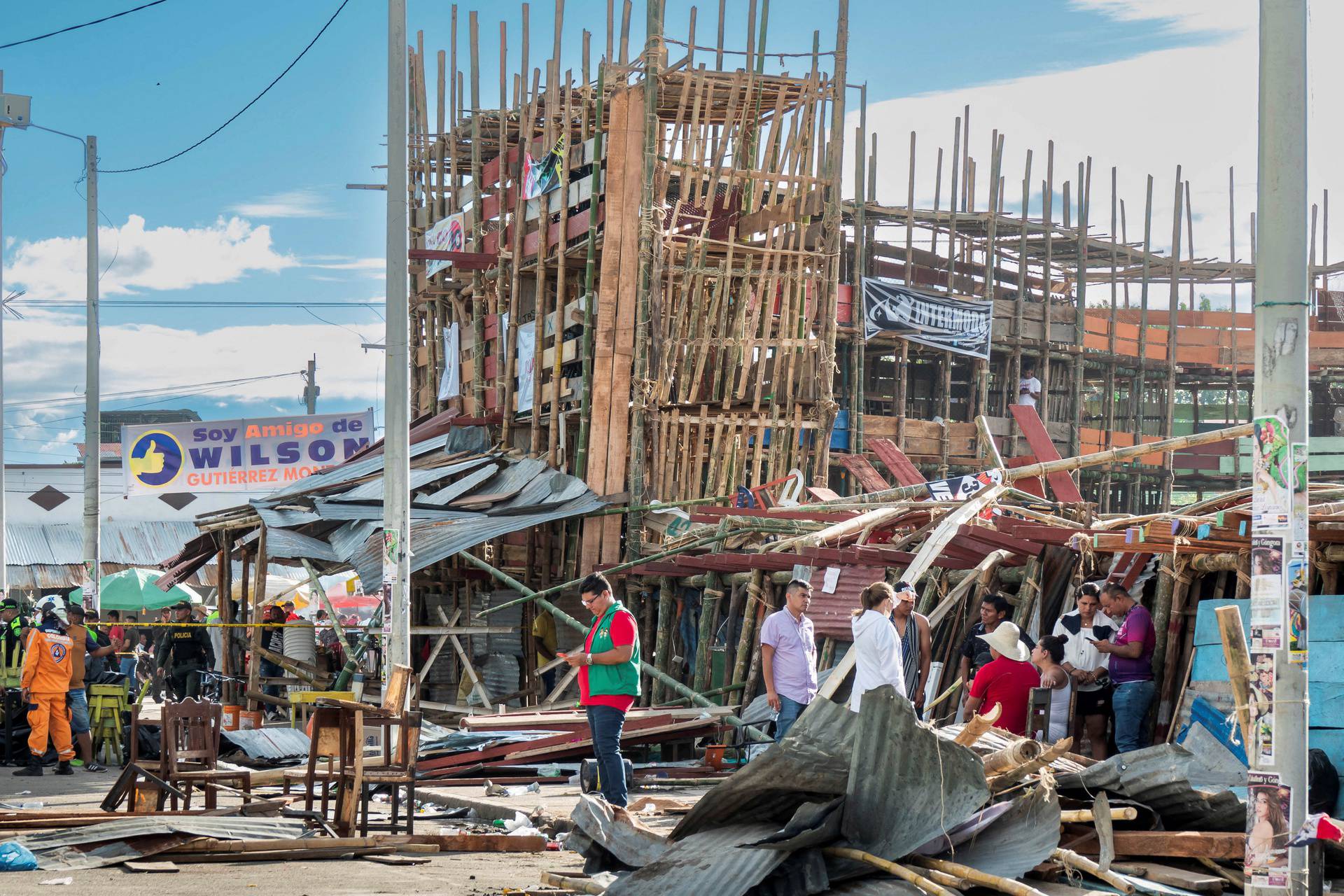 Residents gather near the rubble of a grandstand after it collapsed in a bullring during the celebrations of the San Pedro festivities, in El Espinal