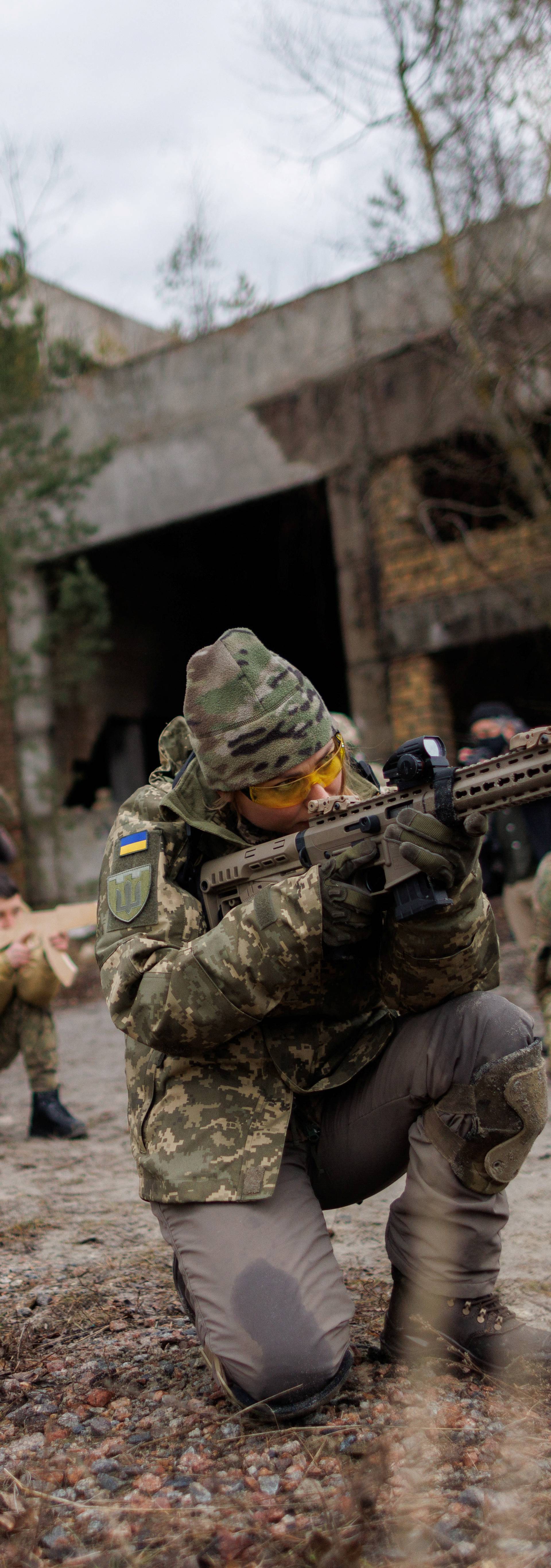 Alisa, a media relations specialist, takes part in a combat skills training conducted by the Territorial Defense Forces near Kyiv