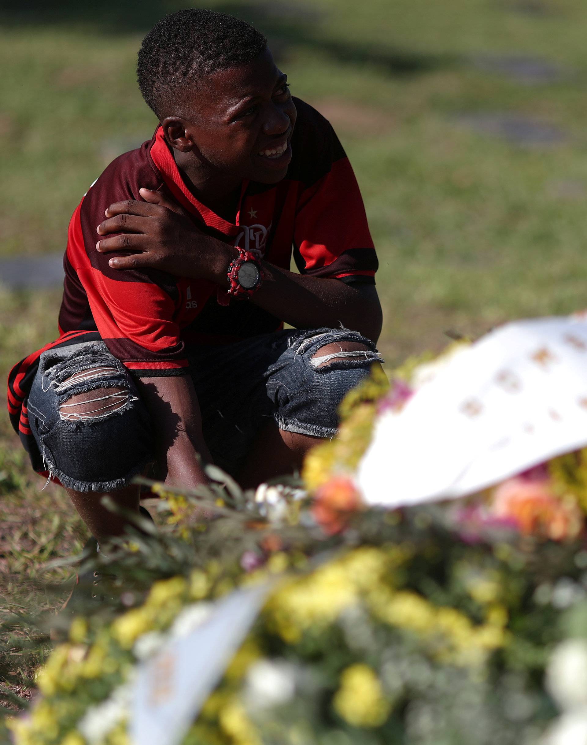 A friend reacts as he attends the funeral service for soccer player Vinicius de Barros Silva Freitas after a deadly fire at Flamengo soccer club's training center, in Volta Redonda