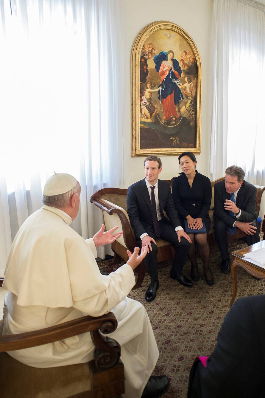 Pope Francis talks to Facebook CEO Zuckerberg and his wife Chan during a meeting at the Vatican 