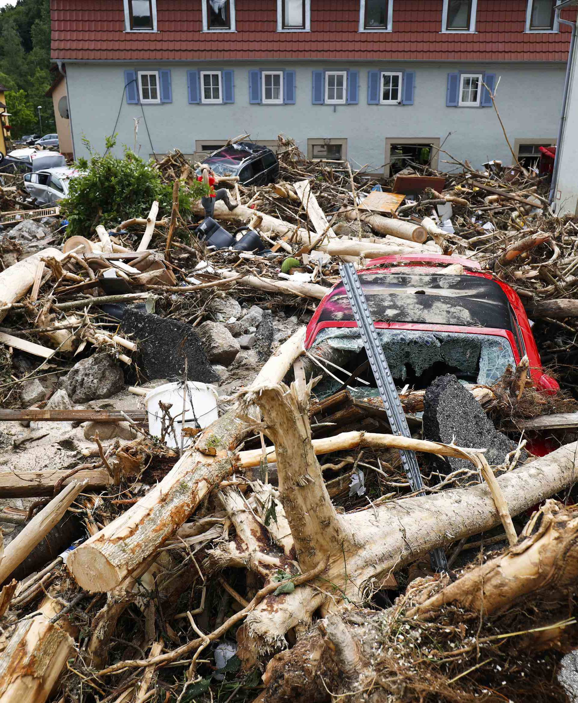 Damaged cars are pictured amid debris after floods in the town of Braunsbach