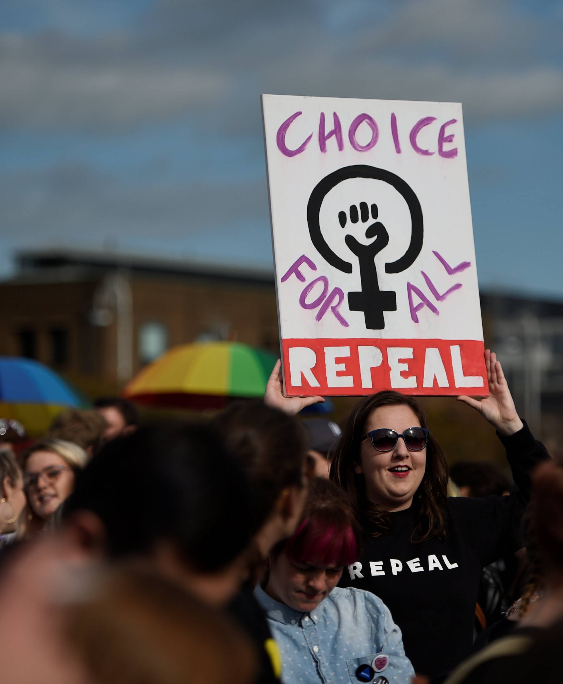 Demonstrators hold posters as they march for more liberal Irish abortion laws, in Dublin