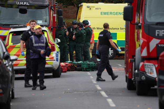 Police officers work at the scene following an incident outside a synagogue, in Manchester