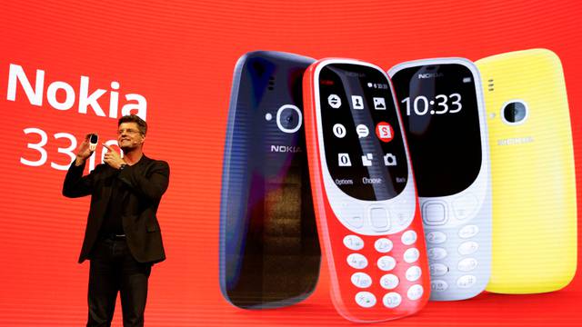 Nummela, CEO of Nokia-HMD, holds up Nokia 3310 device during presentation ceremony at Mobile World Congress in Barcelona