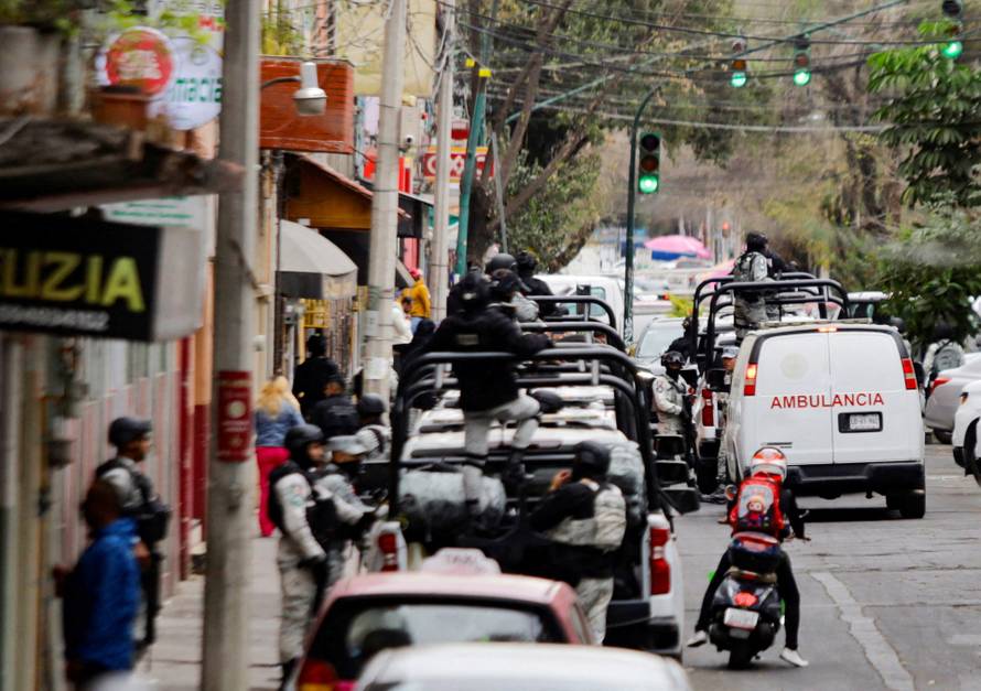 A forensic ambulance believed to be transporting the body of Mexican drug lord Nemesio Oseguera, "El Mencho," leaves the Specialized Prosecutor's Office for Organized Crime (FEMDO), in Mexico City