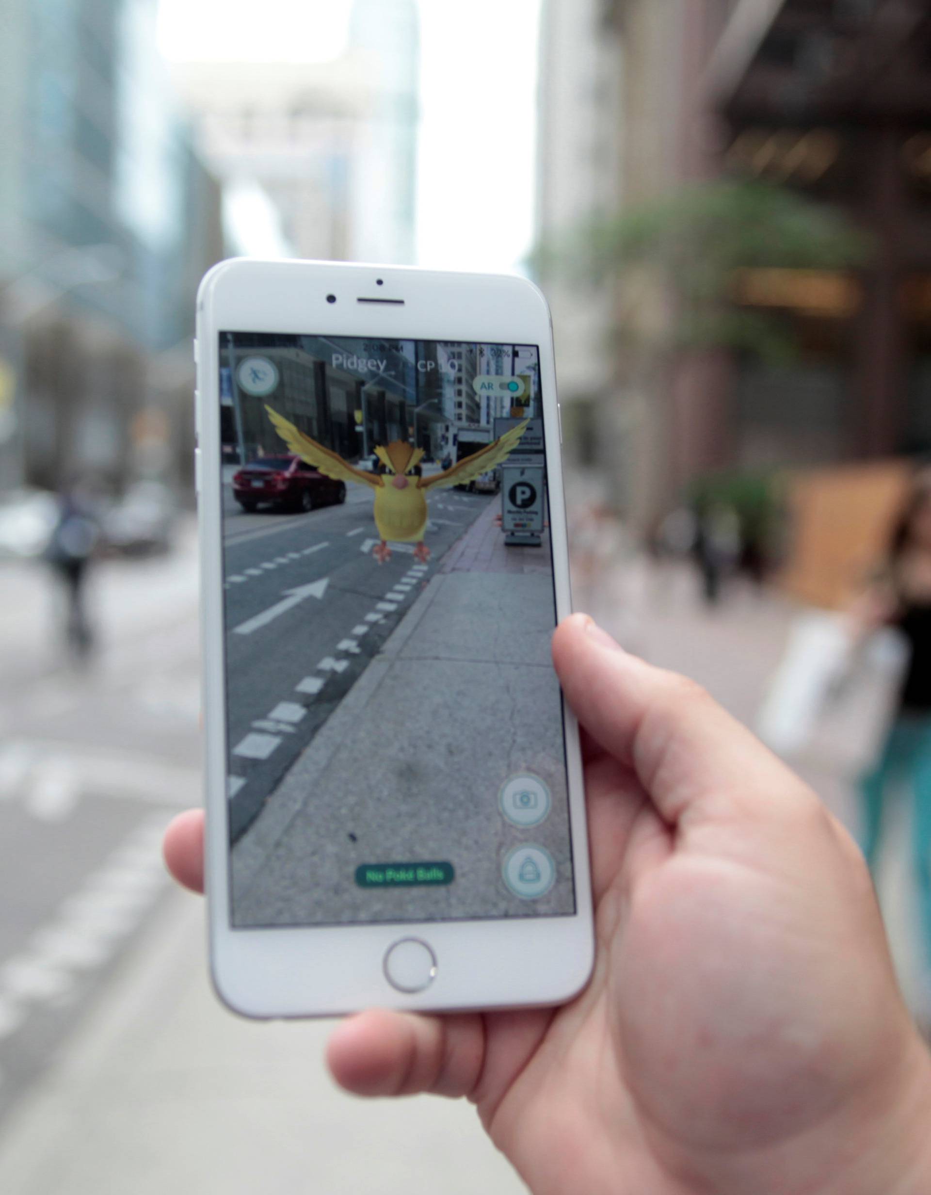 Photo illustration of a "Pidgey" Pokemon seen on the screen of the Pokemon Go mobile app 