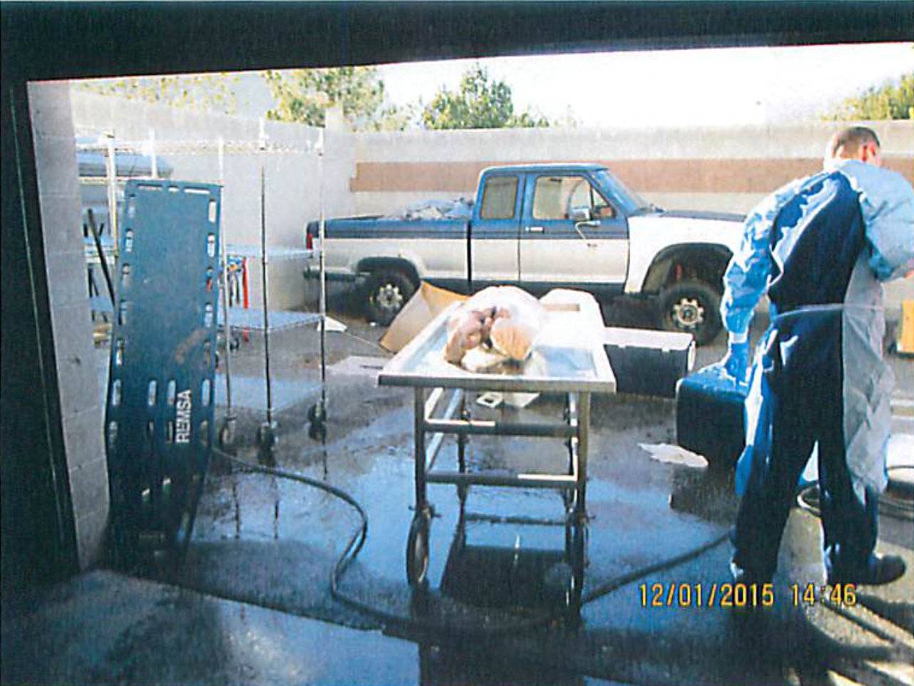 Officials wheel away a stretcher containing a human torso found being thawed with a hose at a facility rented by Southern Nevada Donor Services in Las Vegas, Nevada, U.S. in this handout photo
