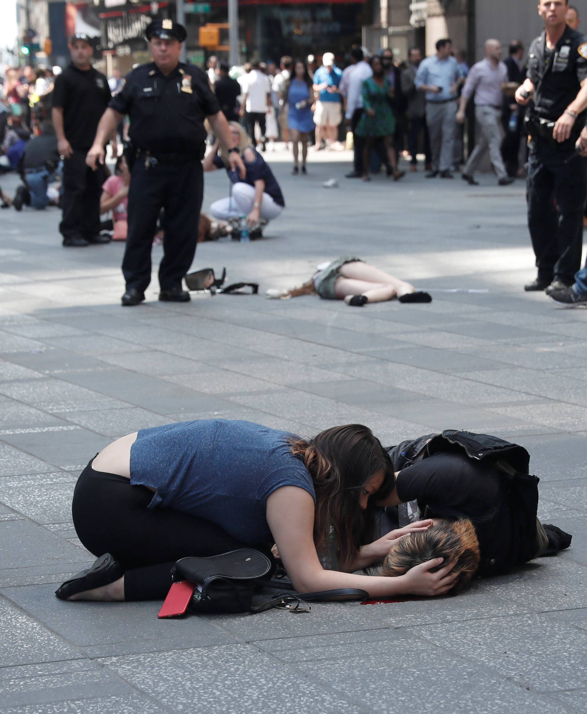 Injured people are seen on the sidewalk in Times Square after a speeding vehicle struck pedestrians on the sidewalk in New York City