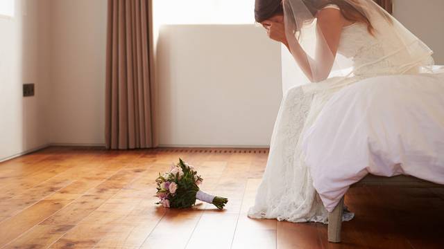 Bride In Bedroom Having Second Thoughts Before Wedding