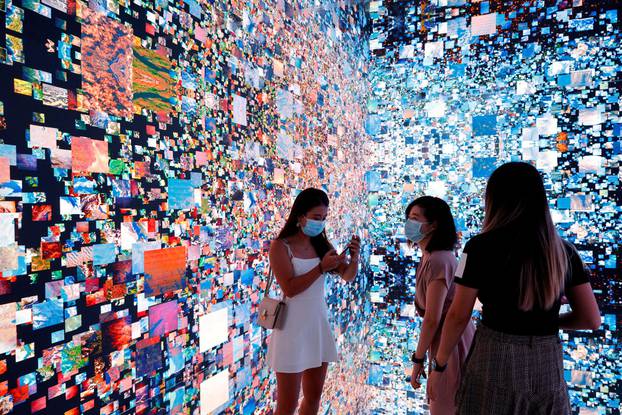 FILE PHOTO: Visitors are pictured in front of an art installation which will be converted into NFT and auctioned online at Sotheby's, in Hong Kong