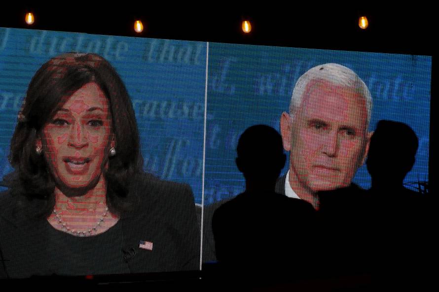 People watch the debate between U.S. Vice President Mike Pence and Democratic vice-presidential nominee Kamala Harris outside a tavern in San Diego