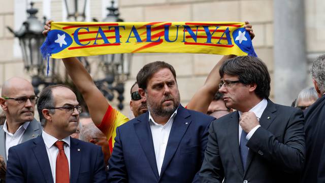 Catalan President Carles Puigdemont and other dignitaries stand in Plaza Sant Jaume in Barcelona