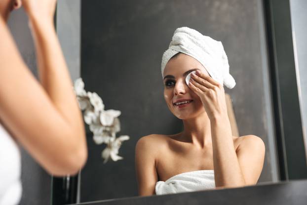 Beautiful young woman wrapped in bath towel