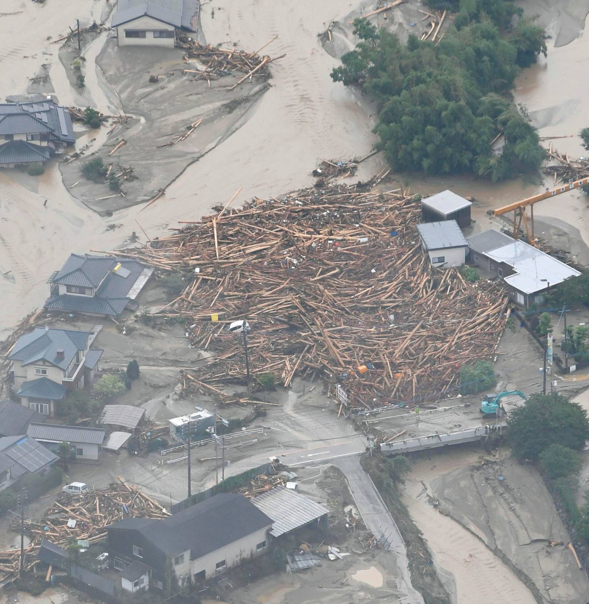Houses damaged by swollen river after heavy rain hit the area, are seen in Asakura